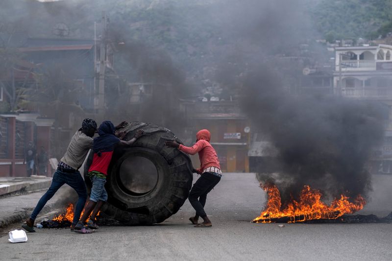&copy; Reuters. Demonstrators set tires on fire during a protest against the assassination of Haitian President Jovenel Moise in Cap-Haitien, Haiti July 22, 2021. REUTERS/Ricardo Arduengo
