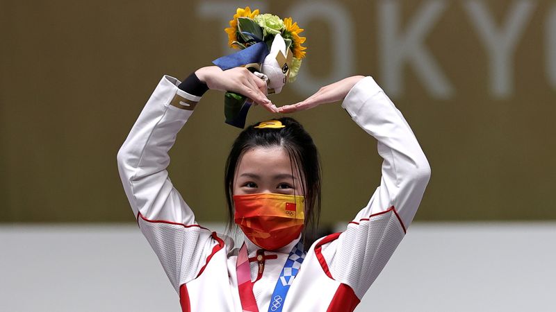 © Reuters. الصينية يانغ قيان تحتفل بفوزها بلقب بندقية ضغط الهواء من مسافة عشرة أمتار في الرماية في أولمبياد طوكيو يوم السبت. تصوير: آن وانج - رويترز.