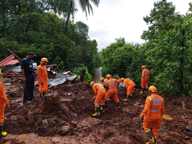 &copy; Reuters. Members of National Disaster Response Force (NDRF) conduct a search and rescue operation after a landslide following heavy rains in Ratnagiri district, Maharashtra state, India, July 25, 2021. National Disaster Response Force/Handout via REUTERS 