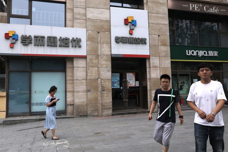 &copy; Reuters. People walk past a Xueersi outlet, a private educational services provider owned by TAL Education Group, in Beijing, China July 26, 2021. REUTERS/Tingshu Wang