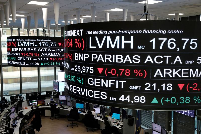 &copy; Reuters. FILE PHOTO: Company stock price information, including that for LVMH Moet Hennessy Louis Vuitton SA, is displayed on screens as they hang above the Paris stock exchange, operated by Euronext NV, in La Defense business district in Paris, France, December 1