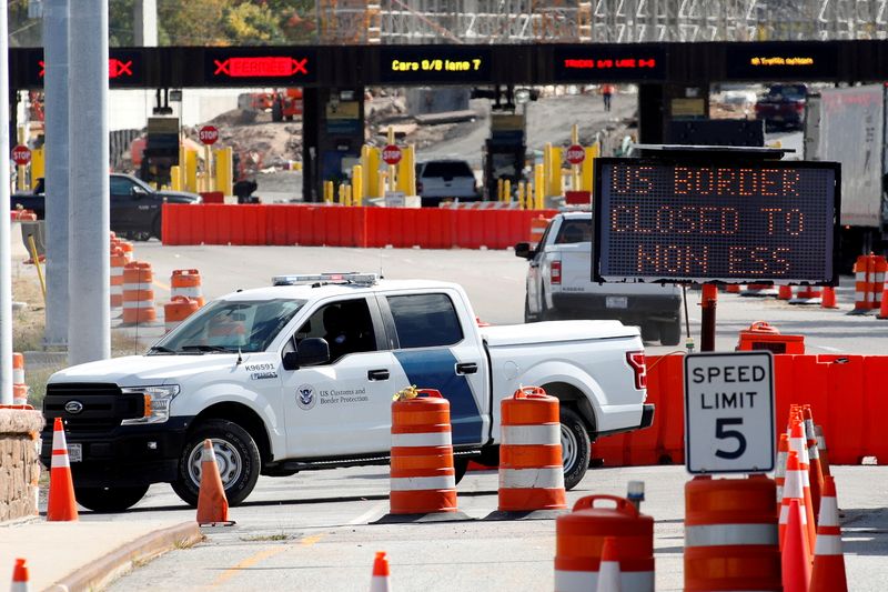 &copy; Reuters. FILE PHOTO: A U.S. Customs and Protection vehicle stands beside a sign reading that the border is closed to non-essential traffic at the Canada-United States border crossing at the Thousand Islands Bridge, to combat the spread of the coronavirus disease (