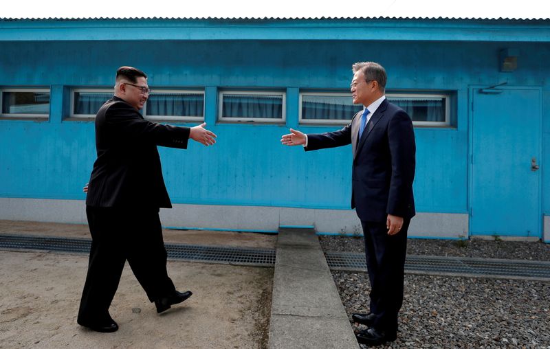 &copy; Reuters. FILE PHOTO: South Korean President Moon Jae-in and North Korean leader Kim Jong Un shake hands at the truce village of Panmunjom inside the demilitarized zone separating the two Koreas, South Korea, April 27, 2018. Korea Summit Press Pool/Pool via Reuters