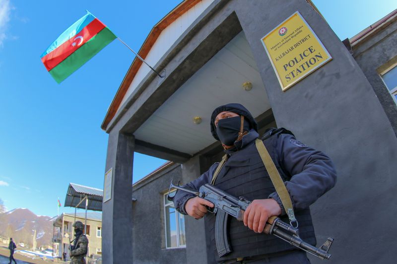 &copy; Reuters. An Azeri police officer guards a police station at the Kalbajar district, Azerbaijan, December 21, 2020. Picture taken December 21, 2020.  REUTERS/Aziz Karimov