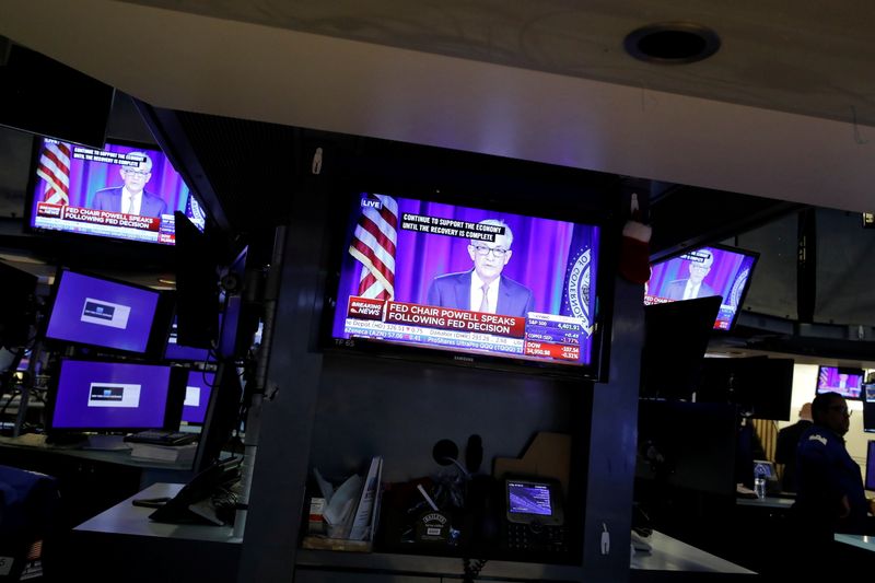 &copy; Reuters. A screen displays a statement by Federal Reserve Chair Jerome Powell following the U.S. Federal Reserve's announcement as a trader works on the trading floor at New York Stock Exchange (NYSE) in New York City, New York, U.S., July 28, 2021. REUTERS/Andrew