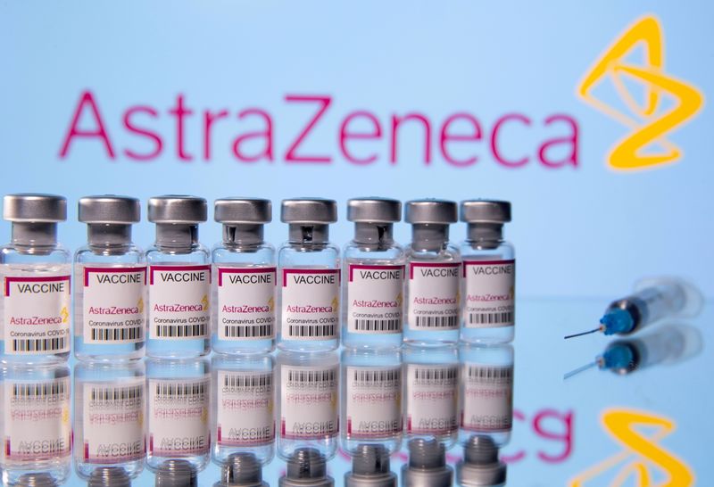 &copy; Reuters. FILE PHOTO: Vials labelled "Astra Zeneca COVID-19 Coronavirus Vaccine" and a syringe are seen in front of a displayed AstraZeneca logo, in this illustration photo taken March 14, 2021. REUTERS/Dado Ruvic/Illustration/File Photo