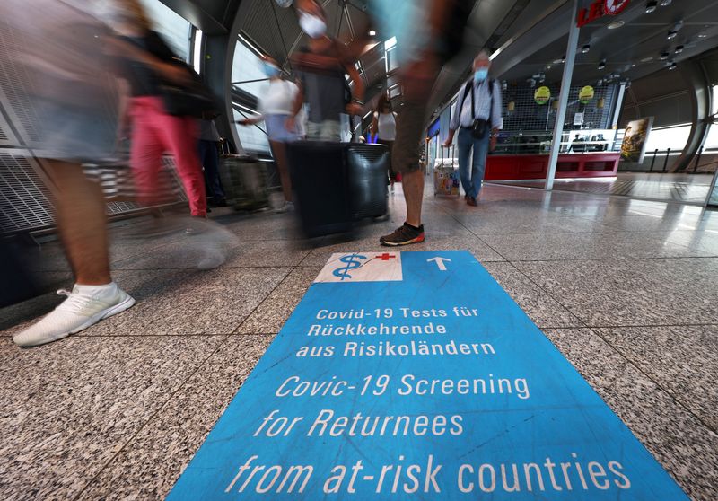 &copy; Reuters. FILE PHOTO: Signs lead the way towards COVID-19 test centres after the outbreak of the coronavirus disease (COVID-19) at the airport in Frankfurt, Germany, August 11, 2020.   REUTERS/Kai Pfaffenbach