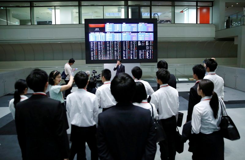 &copy; Reuters. FILE PHOTO: Visitors look at an electronic stock quotation board at the Tokyo Stock Exchange (TSE) in Tokyo, Japan, October 1, 2018.   REUTERS/Toru Hanai