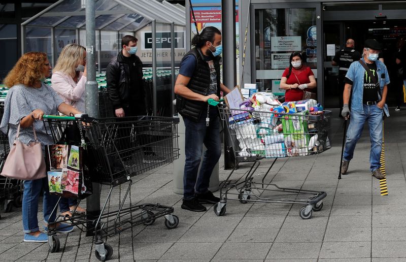 &copy; Reuters. FILE PHOTO:  People are seen in front of the entrance of the Rhein Center shopping mall after the re-opening of the borders, amid the coronavirus disease (COVID-19) outbreak, in Weil am Rhein, Germany June 15, 2020.     REUTERS/Arnd Wiegmann/File photo