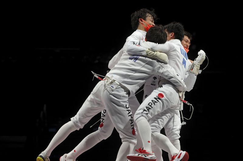 &copy; Reuters. الفريق الياباني يحتفل بفوزه بذهبية فرق الرجال في سيف المبارزة ضمن منافسات السلاح في دورة الألعاب الأولمبية الصيفية في طوكيو يوم الجمعة. تصو