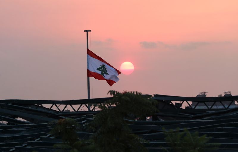 &copy; Reuters. FILE PHOTO: Lebanese flag flutters at the site of last year's Beirut port blast, during sunset in Beirut, Lebanon, July 29, 2021. REUTERS/Mohamed Azakir