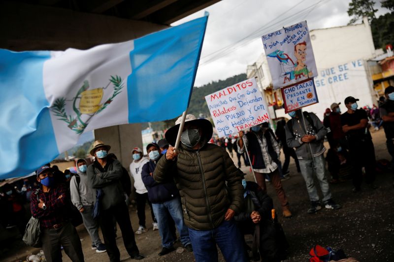 &copy; Reuters. FILE PHOTO: A Mayan indigenous man waves a Guatemala flag during a protest to demand the resignation of Guatemalan President Alejandro Giammattei and Attorney General Maria Porras, in San Cristobal Totonicapan, Guatemala July 29, 2021. REUTERS/Luis Echeve