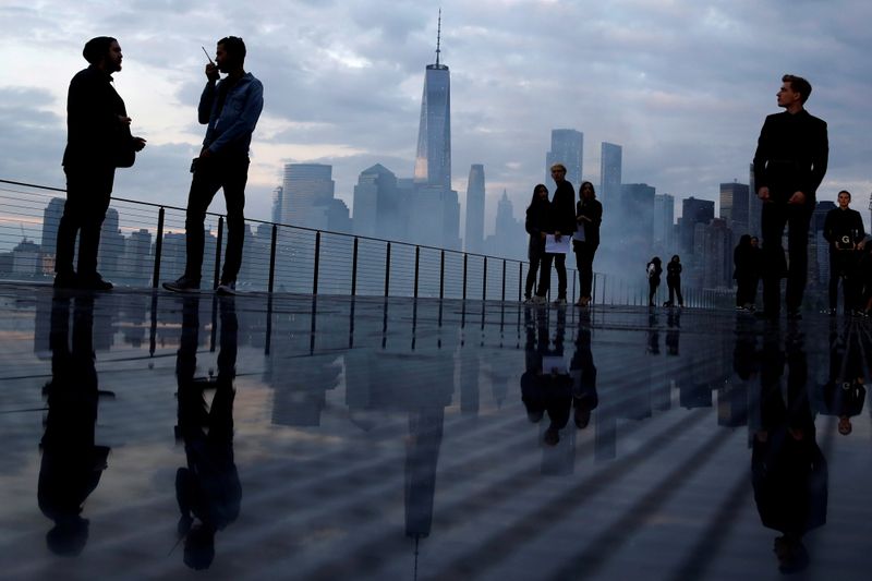 &copy; Reuters. FILE PHOTO: The skyline of downtown Manhattan is seen as people gather on the runway before the Saint Laurent Men's Spring/Summer 2019 collection presentation in Liberty State Park in New Jersey, U.S., June 6, 2018.  REUTERS/Andrew Kelly/File Photo