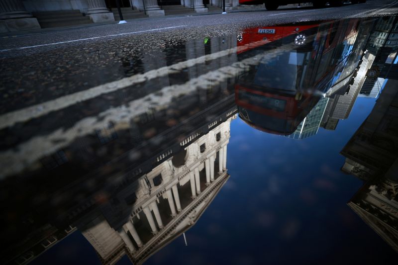 &copy; Reuters. FILE PHOTO: The Bank of England and the City of London financial district are reflected in a puddle, in London, Britain, December 17, 2020. REUTERS/Hannah McKay/File Photo