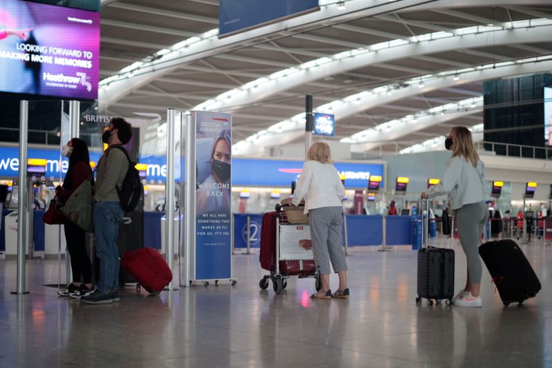 &copy; Reuters. FILE PHOTO: Passengers walk at the Terminal 5 departures area at Heathrow Airport in London, Britain, June 10, 2021. REUTERS/Hannah McKay