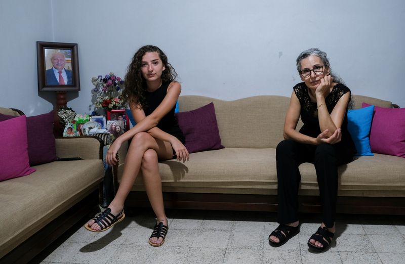 &copy; Reuters. Tatiana Hasrouty, whose father was killed in the August 4 explosion at Beirut port, poses with her mother Ibtissam in her family home in Sin El Fil, Lebanon July 19, 2021. "I was sleeping when the blast happened so it was as if my place of safety and rest