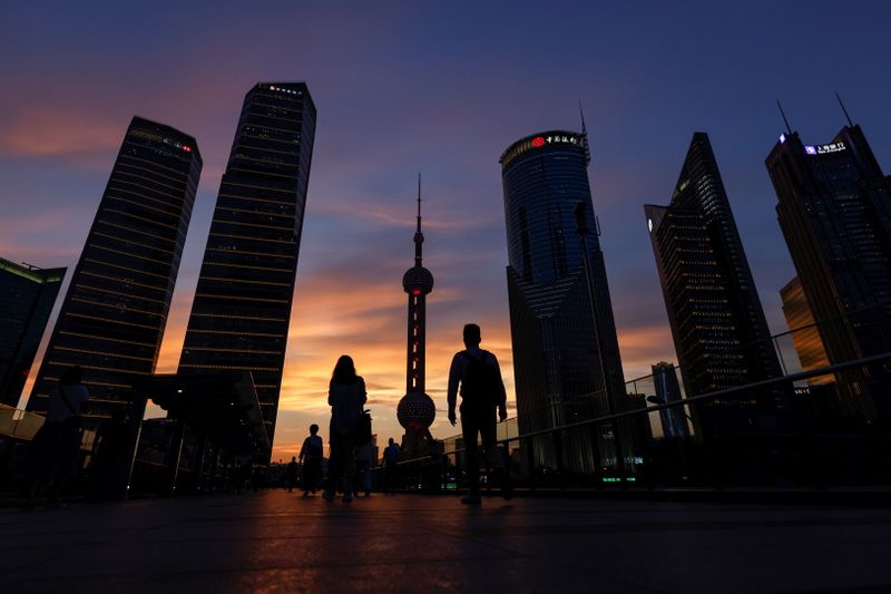 &copy; Reuters. People walk in Lujiazui financial district during sunset in Pudong, Shanghai, China July 13, 2021. Picture taken July 13, 2021. REUTERS/Aly Song