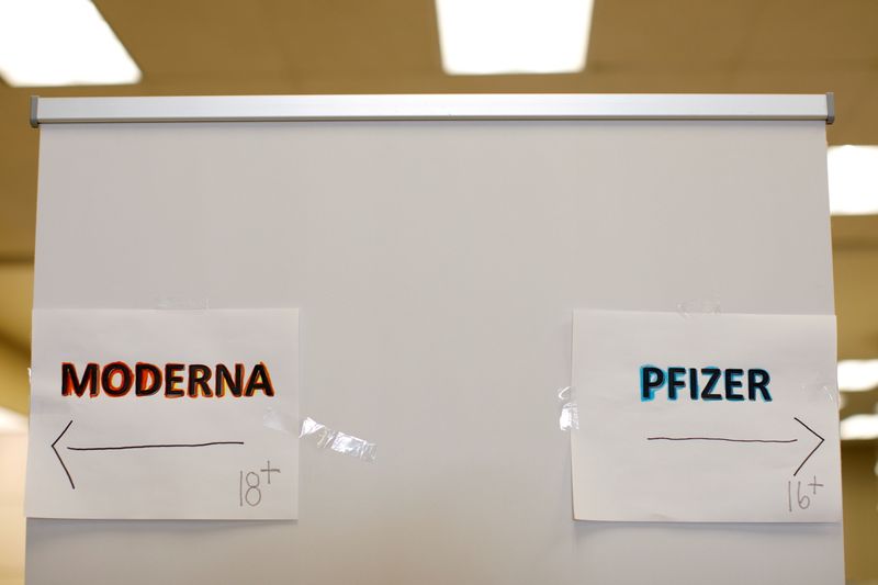 &copy; Reuters. FILE PHOTO: Signs and age groups are shown for the Pfizer and Moderna vaccines at a vaccination center as California opens up vaccine eligibility to any residents 16 years and older during the outbreak of coronavirus disease (COVID-19) in Chula Vista, Cal