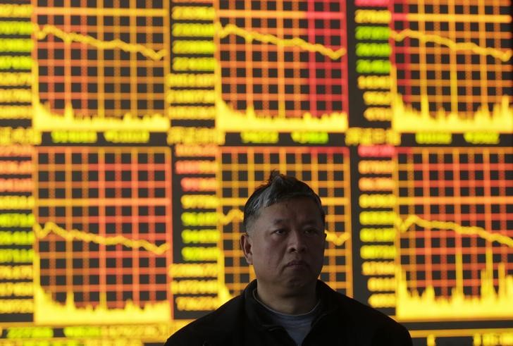 &copy; Reuters. An investor stands in front of an electronic board showing stock information at a brokerage house in Wuhan, Hubei province, March 4, 2013. China's CSI300 share index plunged on Monday to its steepest daily loss since November 2010, with the property and b