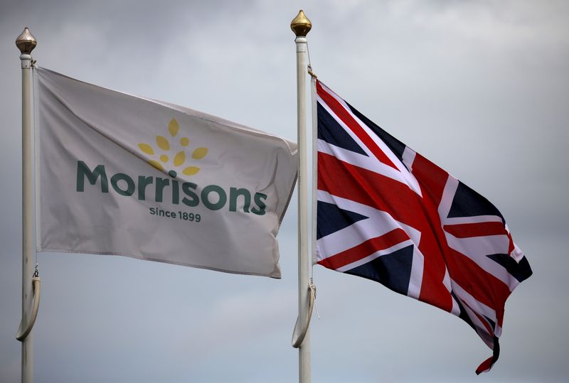 © Reuters. FILE PHOTO: Flags fly outside a Morrisons supermarket in New Brighton, Britain, July 5, 2021. REUTERS/Phil Noble/File Photo