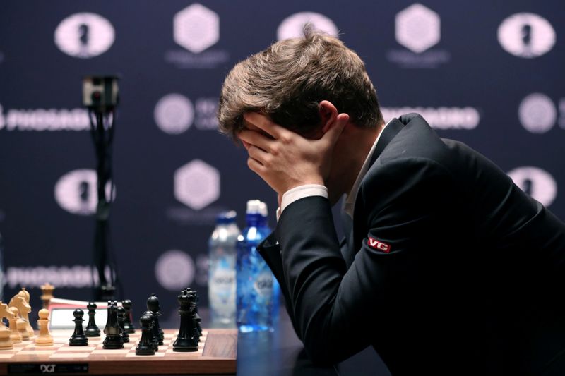 &copy; Reuters. Current World Chess Champion Magnus Carlsen of Norway, reacts to a move from Sergey Karjakin of Russia during the first game of their rapid chess tie-breaker match, at the 2016 World Chess Championship match in New York, U.S., November 30, 2016. REUTERS/M