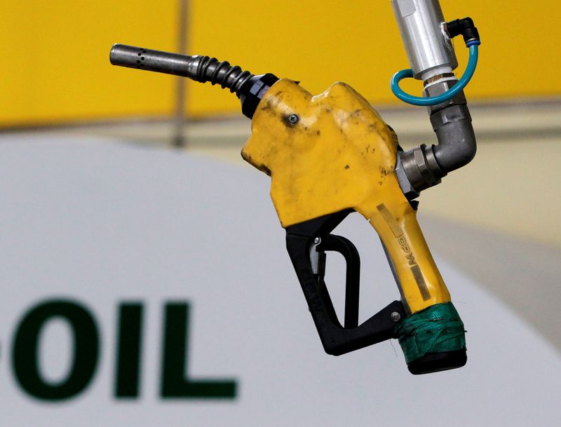 &copy; Reuters. FILE PHOTO: A gas pump is seen hanging from the ceiling at a petrol station in Seoul June 27, 2011. REUTERS/Jo Yong-Hak/File Photo