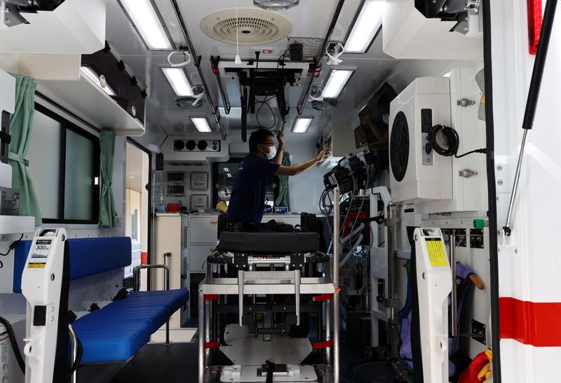 &copy; Reuters. Nippon Medical School Hospital's ICU doctor Shoji Yokobori checks the devices of an ambulance, to prevent the spread of COVID-19 at the hospital in Tokyo, Japan, August 1, 2021. Picture taken on August 1, 2021.  REUTERS/Kim Kyung-Hoon/Files