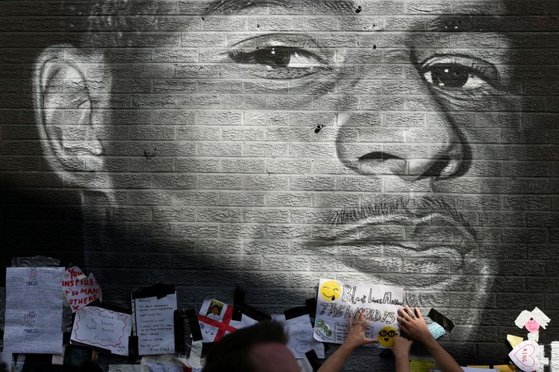 &copy; Reuters. FILE PHOTO: Stand Up to Racism Demonstration at the Marcus Rashford mural after it was defaced following the Euro 2020 Final between Italy and England - Withington, Manchester, Britain - July 13, 2021. REUTERS/Peter Powell/File Photo