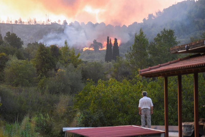 &copy; Reuters. Flames rise as a wildfire burns near the site of ancient Olympia, Greece, August 5, 2021. Intimenews via REUTERS 