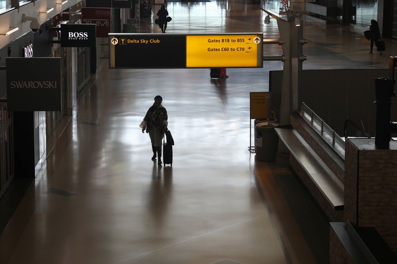 &copy; Reuters. FILE PHOTO: Air travelers walk through a terminal as the coronavirus disease (COVID-19) outbreak continues, at New York’s JFK International Airport in New York, U.S., May 15, 2020. REUTERS/Shannon Stapleton