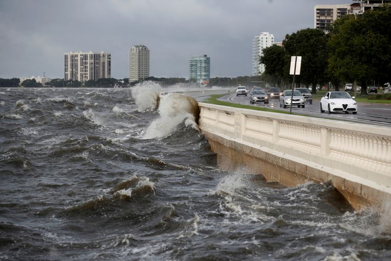&copy; Reuters. FILE PHOTO: Waves crash the balustrades on Bayshore Boulevard during high tide after Tropical Storm Elsa churns up the Gulf coast, in Tampa, Florida, U.S., July 7, 2021. REUTERS/Octavio Jones/File Photo