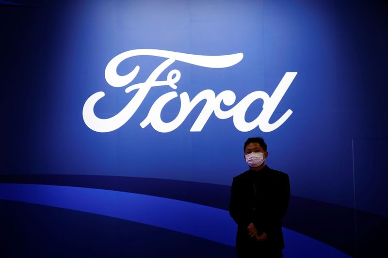 &copy; Reuters. A man stands near the Ford logo during a media day for the Auto Shanghai show in Shanghai, China April 19, 2021. REUTERS/Aly Song/Files