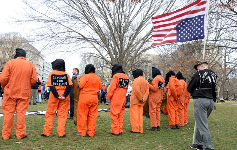 &copy; Reuters. FILE PHOTO: Activists wearing prison jumpsuits and black hoods participate in a demonstration against the Guantanamo Bay detention camp, opened 18 years ago, and calling for its closure and "accountability for torture", near the White House, in Washington