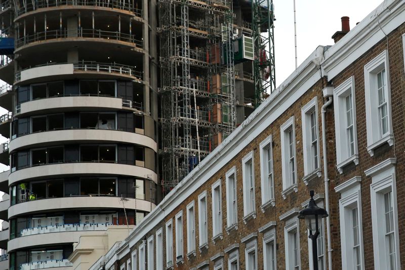 &copy; Reuters. An apartment block is constructed behind a row of traditional properties in central London December 11, 2014.  REUTERS/Luke MacGregor   