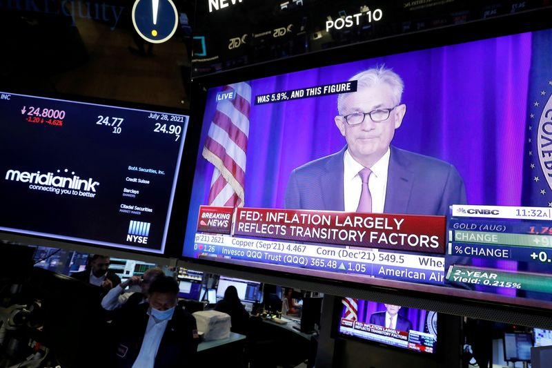 &copy; Reuters. FILE PHOTO: A screen displays a statement by Federal Reserve Chair Jerome Powell following the U.S. Federal Reserve's announcement as traders work on the trading floor at New York Stock Exchange (NYSE) in New York City, New York U.S., July 28, 2021. REUTE