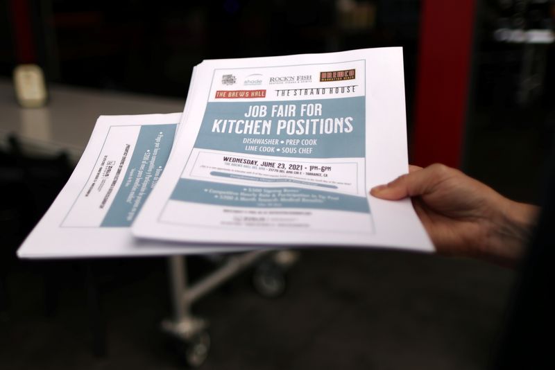 &copy; Reuters. FILE PHOTO: A woman holds fliers for a job fair for restaurant and hotel workers, after coronavirus disease (COVID-19) restrictions were lifted, in Torrance, near Los Angeles, California, U.S., June 23, 2021. REUTERS/Lucy Nicholson