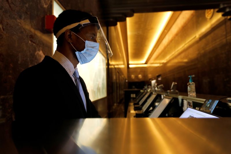 &copy; Reuters. FILE PHOTO: An employee wears a protective face mask and face shield in the main lobby of the Empire State Building in New York City, New York, U.S., June 24, 2020. Picture taken June 24, 2020. REUTERS/Mike Segar/File Photo