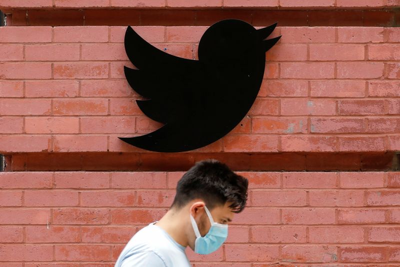 &copy; Reuters. FILE PHOTO: A person in a mask walks by the New York Twitter offices after they announced they will close their re-opened offices effective immediately in response to updated CDC guidelines during the outbreak of the coronavirus disease (COVID-19) in Manh