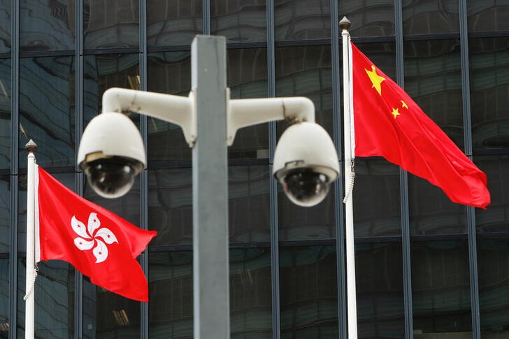 &copy; Reuters. Hong Kong and Chinese national flags are flown behind a pair of surveillance cameras outside the Central Government Offices in Hong Kong, China July 20, 2020. REUTERS/Tyrone Siu