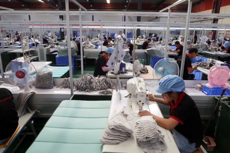 © Reuters. Employees work on the production line of American infant product and toy manufacturer Kids II Inc. at a factory in Jiujiang, Jiangxi province, China June 22, 2021. Picture taken June 22, 2021. REUTERS/Gabriel Crossley
