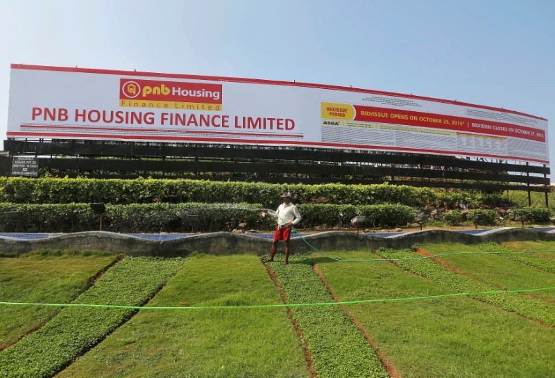 &copy; Reuters. A gardener waters a lawn in front of an advertisement for India's PNB Housing Finance Ltd. initial public offering (IPO) in Mumbai, India, October 25, 2016. REUTERS/Shailesh Andrade/Files