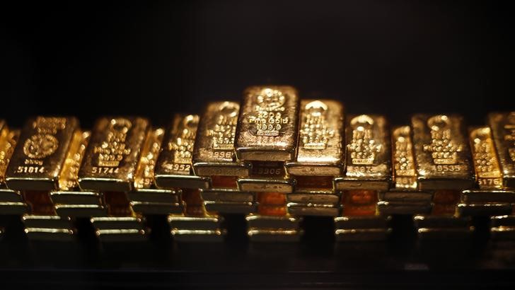 &copy; Reuters. Gold bars are stacked at a safe deposit room of the ProAurum gold house in Munich March 6, 2014. Gold was flat on Thursday as diplomatic efforts to cool the Ukraine crisis depressed demand for assets seen as safe, but the metal found support above $1,330 