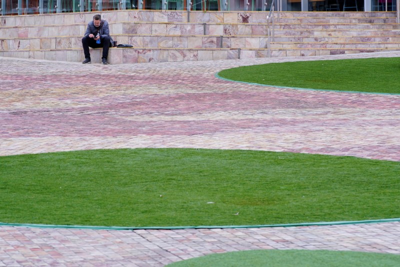 &copy; Reuters. A lone man sits at a deserted Federation Square on the first day of a lockdown, as the state of Victoria looks to curb the spread of a coronavirus disease (COVID-19) outbreak in Melbourne, Australia, July 16, 2021.  REUTERS/Sandra Sanders - RC2GLO92G6J7