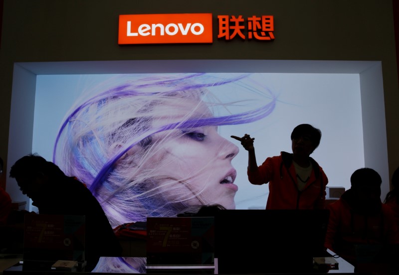 &copy; Reuters. FILE PHOTO:  An employee gestures next to a Lenovo logo at Lenovo Tech World in Beijing, China November 15, 2019. REUTERS/Jason Lee/File photo