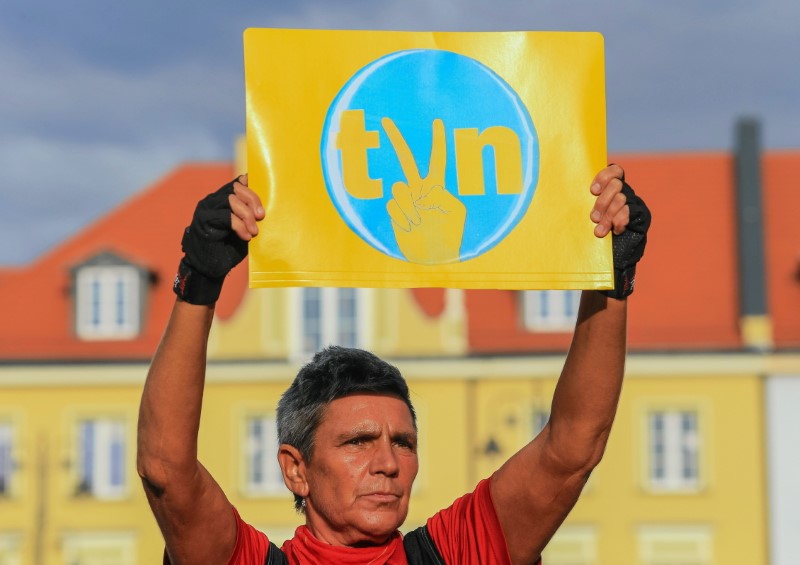 &copy; Reuters. FILE PHOTO: A protester holds a placard with the logo of the TVN Group during a demonstration in defence of media freedom and against a proposed amendment to the country's broadcast media law regarding the share of foreign capital in Polish media, in Bydg