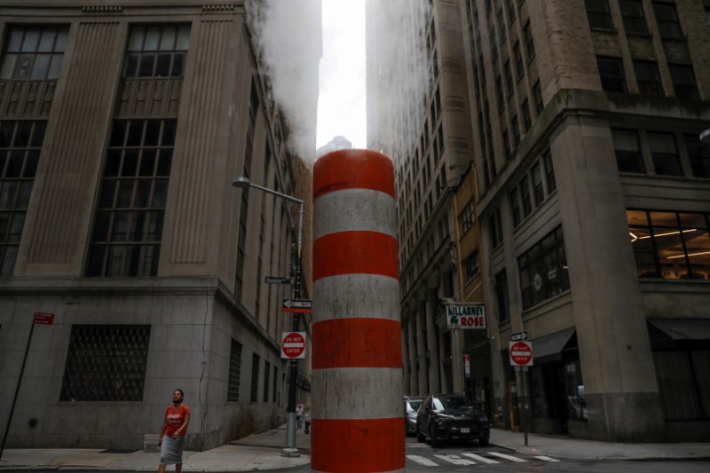 &copy; Reuters. FILE PHOTO: A person walks by a steam pipe in the Financial District after The United Nations released the Intergovernmental Panel on Climate Change's (IPCC) latest report, in Manhattan, New York City, U.S., August 9, 2021. REUTERS/Andrew Kelly/File Photo