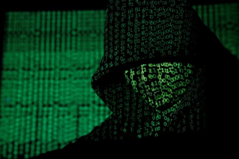 &copy; Reuters. FILE PHOTO: A projection of cyber code on a hooded man is pictured in this illustration picture taken on May 13,  2017. REUTERS/Kacper Pempel/Illustration/File Photo
