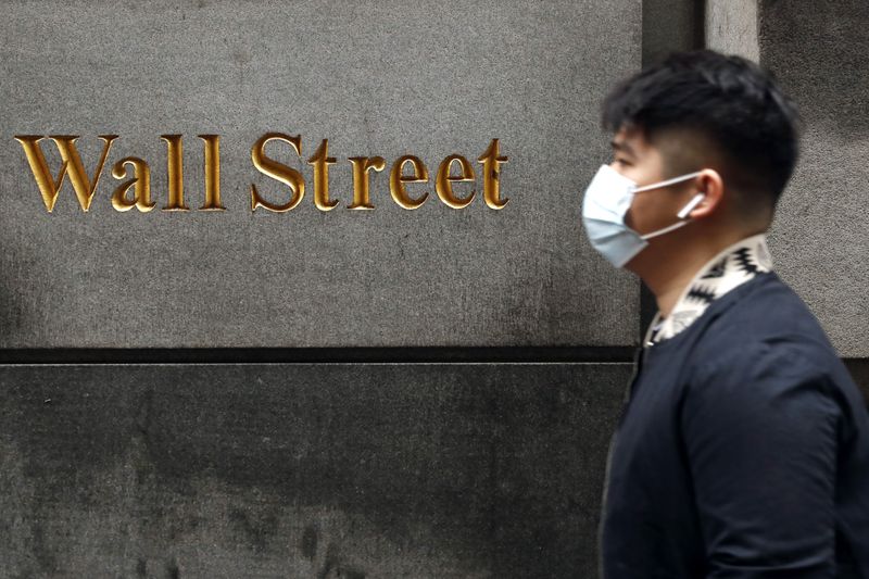 &copy; Reuters. FILE PHOTO: A man wears a protective mask as he walks on Wall Street during the coronavirus outbreak in New York City, New York, U.S., March 13, 2020. REUTERS/Lucas Jackson