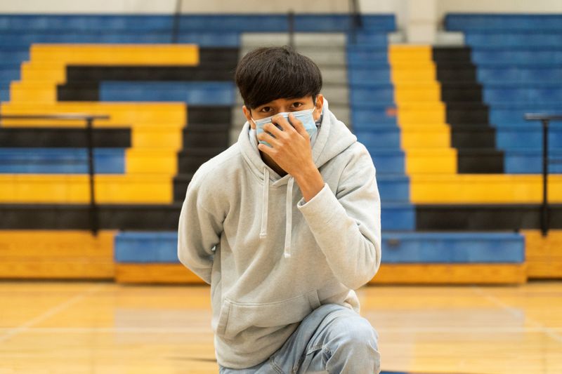 &copy; Reuters. FILE PHOTO: A sophomore student at Louise High School Antonio Martinez, 15, also a cross country runner,  wears a mask as he poses, during the coronavirus disease (COVID-19) pandemic in Louise, Texas, U.S., November 20, 2020. REUTERS/Go Nakamura