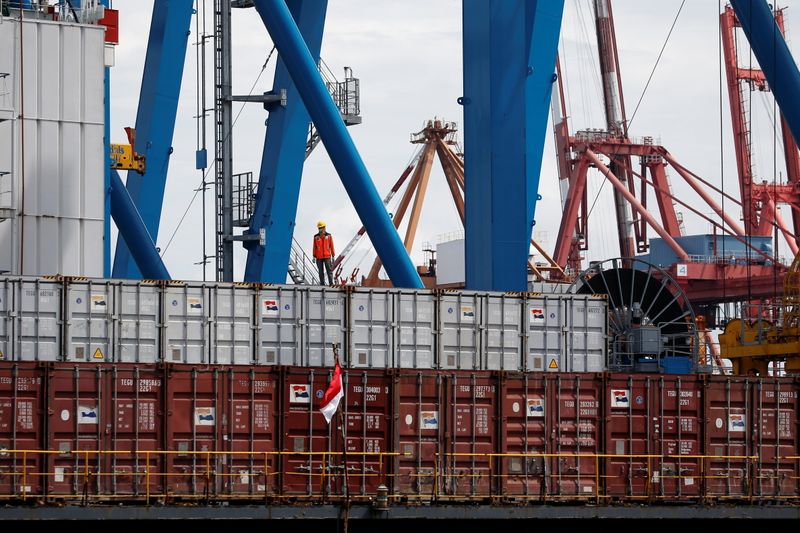 &copy; Reuters. A worker stands on a container at Tanjung Priok Port in Jakarta, Indonesia, January 11, 2021. Picture taken January 11, 2021. REUTERS/Willy Kurniawan